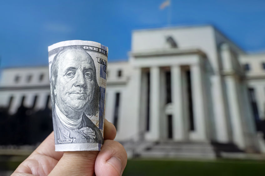 a hundred dollar bill on the background central bank. Federal Reserve Building in Washington United States