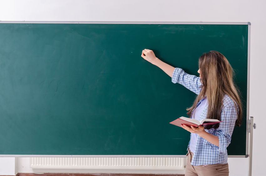 Female student in front of chalkboard