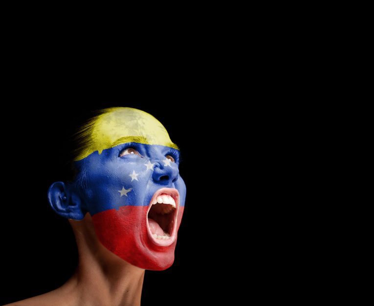 19538005 the venezuelan flag on the face of a screaming woman concept