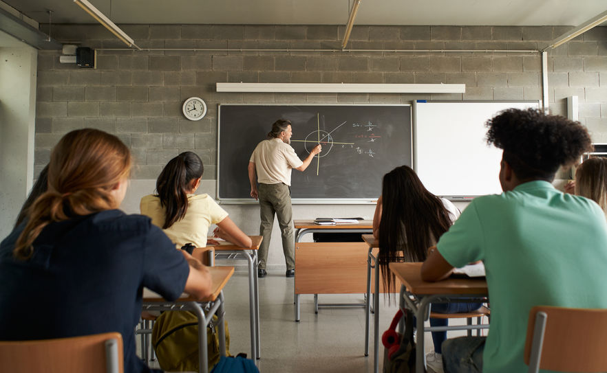 Mathematics teacher teaching classes at the major school. Back to school.