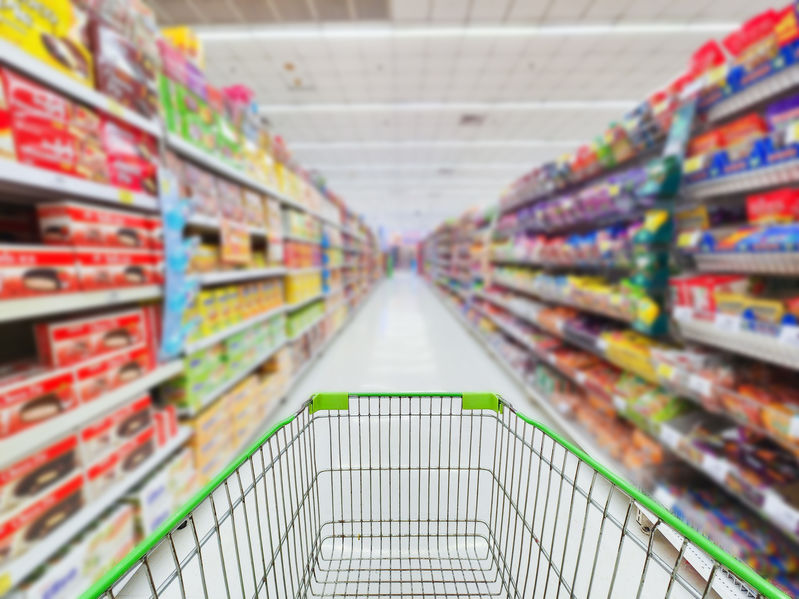 Supermarket concept Shopping cart and blurry picture