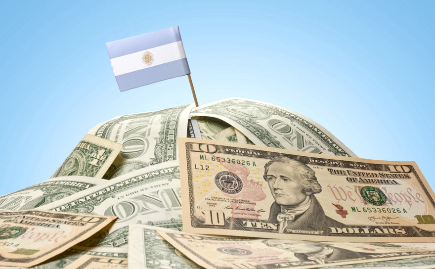 Flag of Argentina sticking in a pile of american dollars.(series