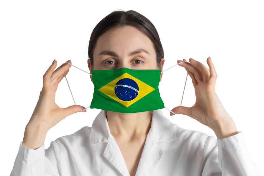 Respirator with flag of Brazil Doctor puts on medical face mask isolated on white background