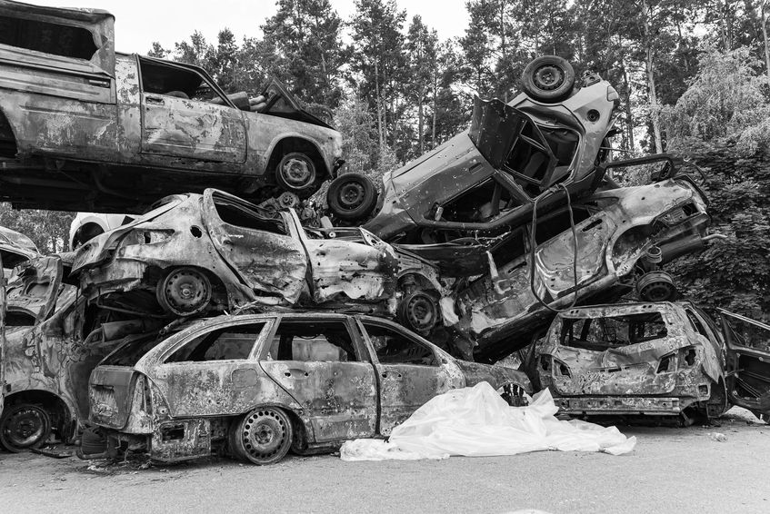 Shot and burned cars during the war in Ukraine, black and white photo