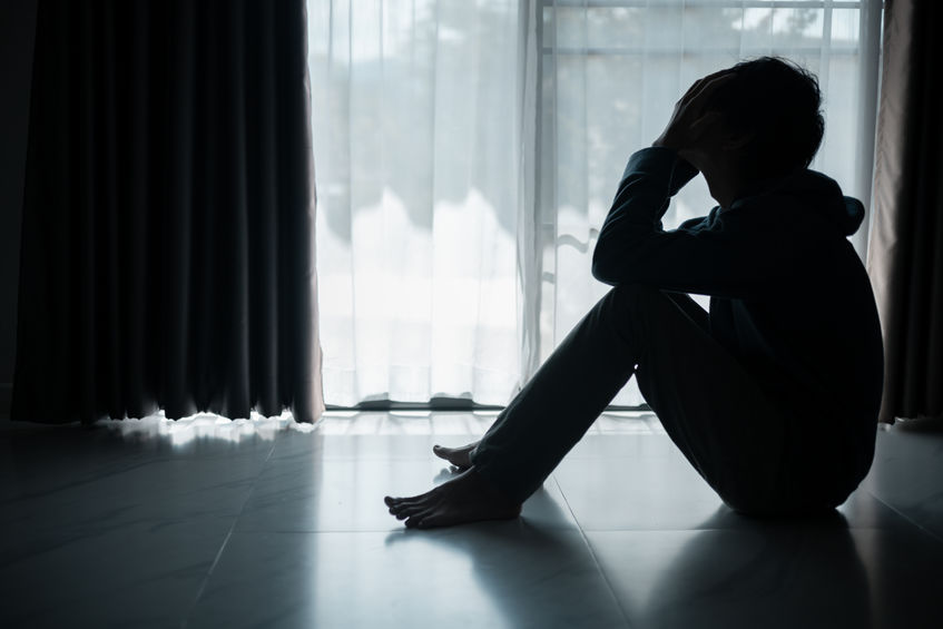 Silhouette of lost cast long shadow, embodying deep despair and hopelessness left him feeling perpetually stressed, sad, and unhappy. man sat alone, feeling weight of anxiety, stress, and depression.