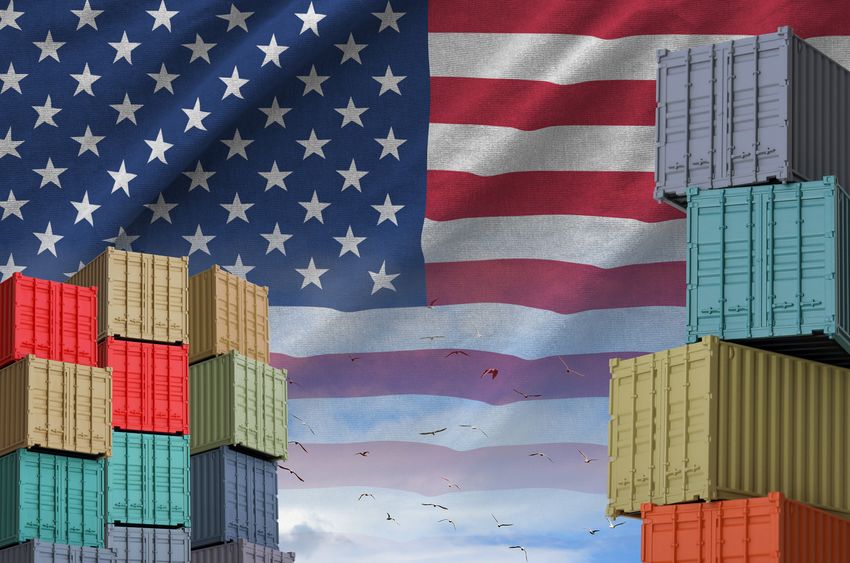 United States of America flag and big stack of shipping cargo containers in docks with sky background