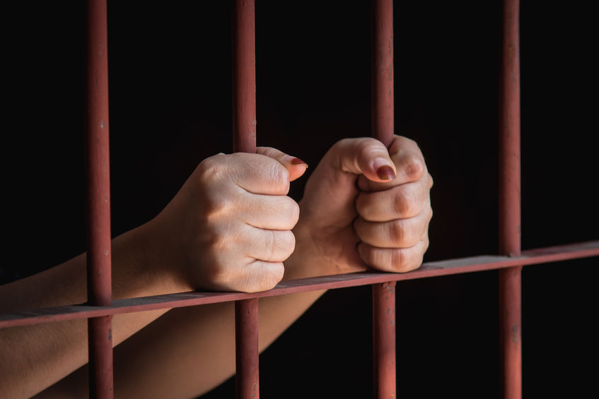 Woman hand in jail